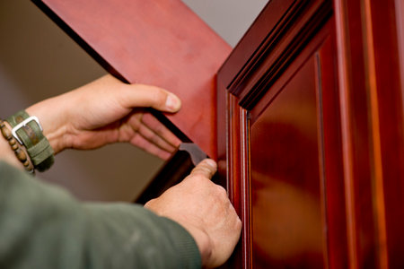 man working on the new kitchen cabinetの写真素材