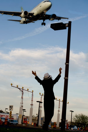 Happy  woman aircraft pilot over blue sky background のeditorial素材