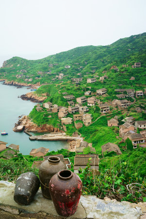 The decline of fisheries resources, China Zhejiang Shengsi Shengshan Island fishermen have relocated, becoming no village, abandoned houses covered with green plantsの写真素材