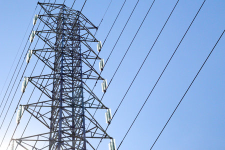 Electric tower, Electric PowerTransmission, High Voltage Power Lines with blue sky and sunset . -...