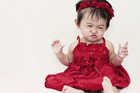 Little baby girl with funny expressionの写真素材
