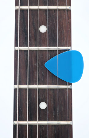 electric guitar fingerboard with dot inlay and a pick の写真素材