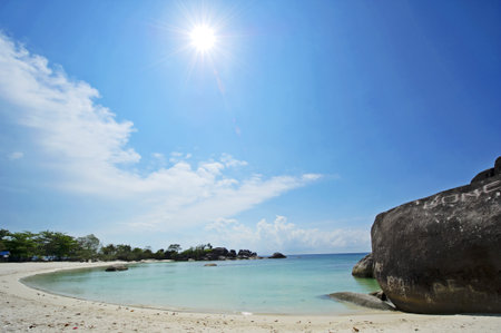 The rocks, the beach and the blue skyの写真素材
