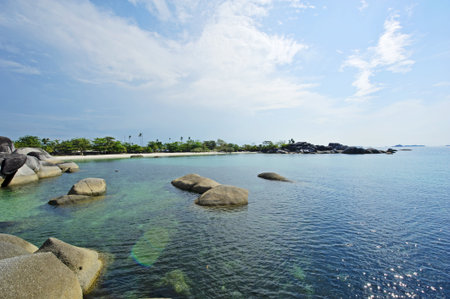 The rocks, the beach and the blue skyの写真素材