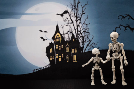 Skeleton and little skeleton with Halloween backgroundの写真素材