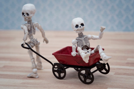 Skeleton kids playing toy wagonの写真素材