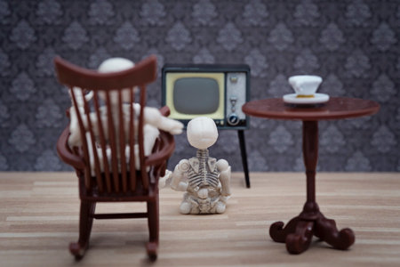 skeleton and little skeleton watching TVの写真素材