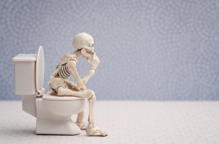 Skeleton sitting on water closet while thinkingの写真素材