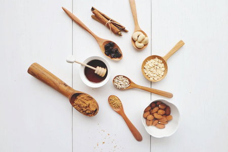 Cashew nuts, raisins, oats, honey, almonds, cinnamon and seedsの写真素材