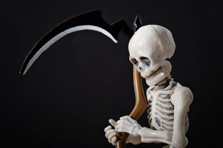 A close-up portrait of a skeleton holding scytheの写真素材