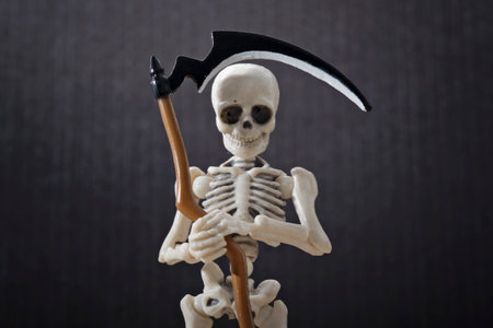 A close-up portrait of a skeleton holding scytheの写真素材