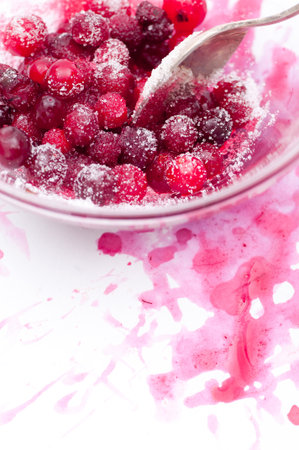 Sugared fresh cranberries with cranberry splash space for your text の写真素材