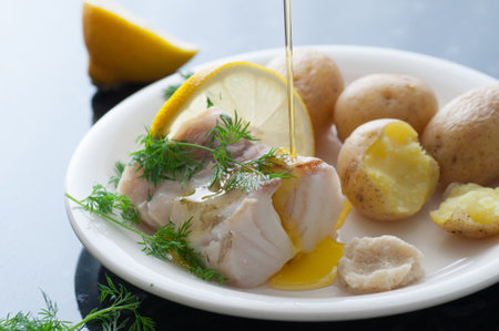 Back of cod fillet, potato, dill, horseradish, lemon and melted butter.の写真素材