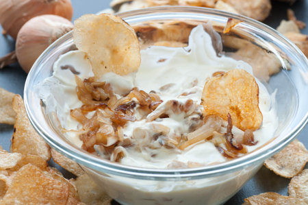 Caramelized onion dip with potato chips.の写真素材