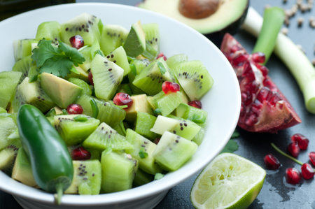 Kiwi, avocado, cilantro, jalapeno and pomegranate seeds, Add olive oil, salt and pepper.の写真素材