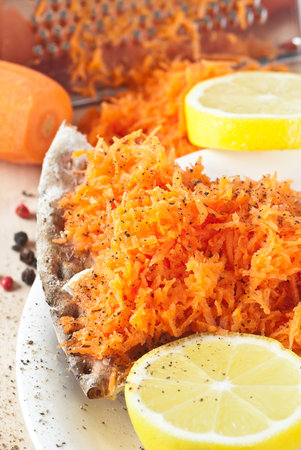 Crispbread with grated carrot.  Seasoned with lemon and black pepper.の写真素材