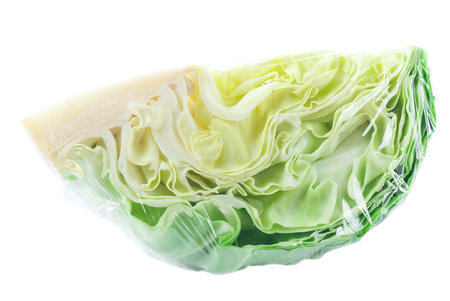 Plastic wrapped cabbage on white background.の写真素材