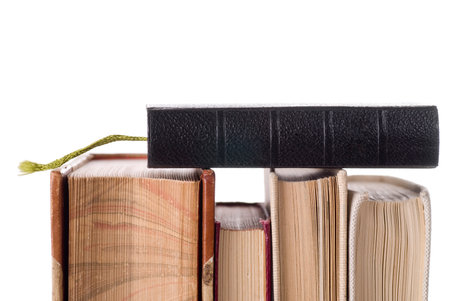 Black, brown and white vintage books on white background.