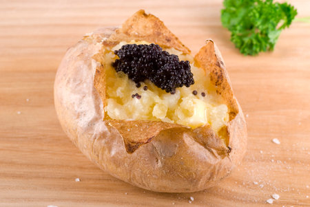 Baked jacket potato with caviar, melted butter and sea salt.の写真素材