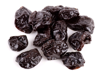 Dried plums close up background.の写真素材