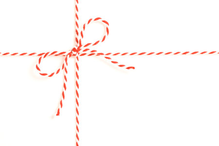 Parcel wrapped in white paper with red and white striped string.の写真素材