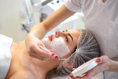 Spa facial mask application. Spa beauty organic facial mask application at day spa salon.
