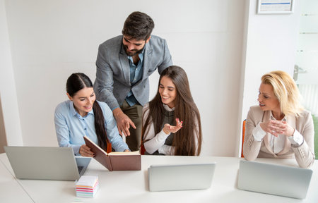 Collaborative colleagues working together on a common office project.の写真素材
