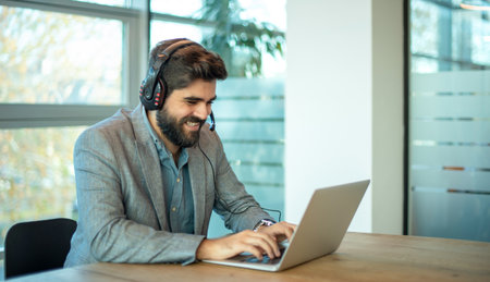 Smiling business man wearing headset for video conference, communication, education and e-learning.の写真素材