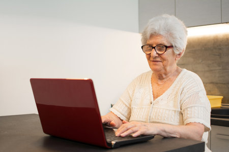 Senior woman using laptop computer at home