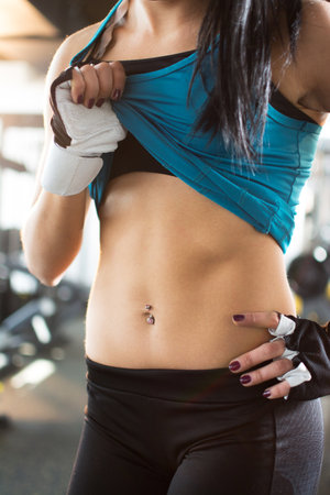 Close-up of a womans body bodybuilder in the gymの写真素材