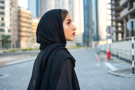 Side view portrait of beautiful Arab young woman wearing traditional arabic clothing.