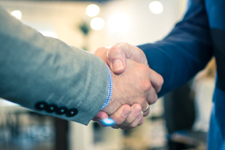 Close up of businessmen shaking hands.の写真素材