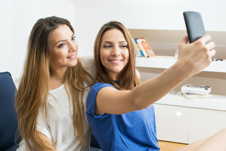 Friends taking a selfie at home.の写真素材