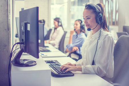 Support phone operator woman in headset at workplaceの写真素材