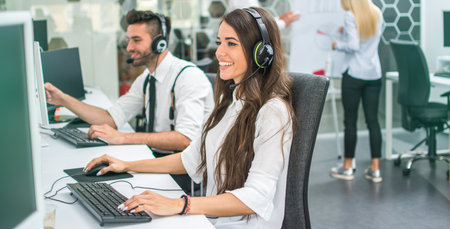 Friendly customer support service agents working in office.の写真素材