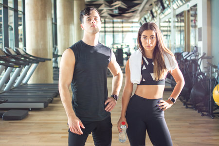 Sporty woman and man in sportswear at gym.の写真素材
