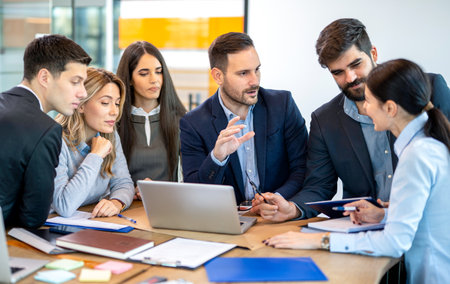 Business team leader is explaining new company decisions and strategies to team for successful business developmentの写真素材