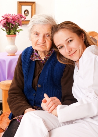 Young doctor holds the old woman's handsの写真素材