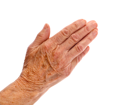Elderly woman hand on an isolated backgroundの写真素材