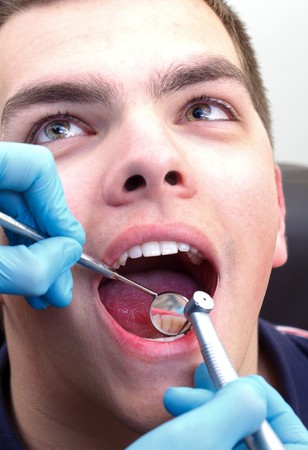 Scared man at hospital, visiting dentistの写真素材
