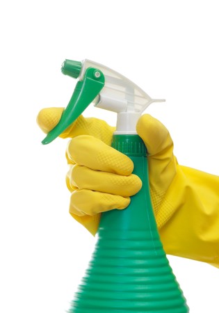 Hand with yellow glove holding cleaning productの写真素材