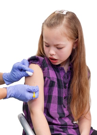 Portrait of a girl who gets an injection in her armの写真素材
