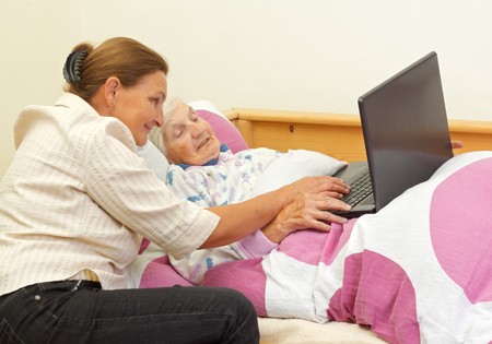 Elderly woman learns to use the  computerの写真素材