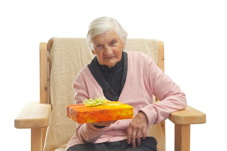 Portrait of an elderly woman holding a giftboxの写真素材