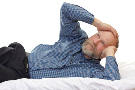 Portrait of an aged man suffering of headacheの写真素材