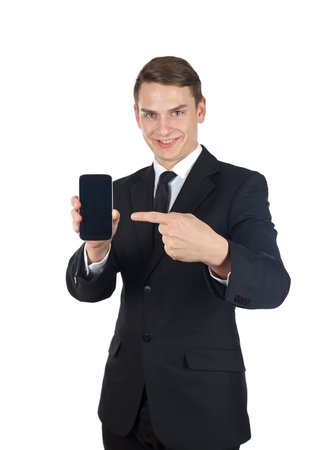 Portrait of a confident businessman holding a smartphone on  isolated の写真素材