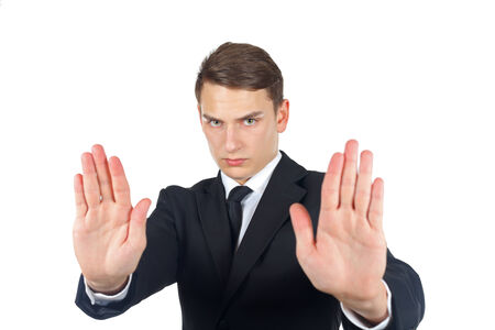 Serious businessman making stop gesture on isolated の写真素材