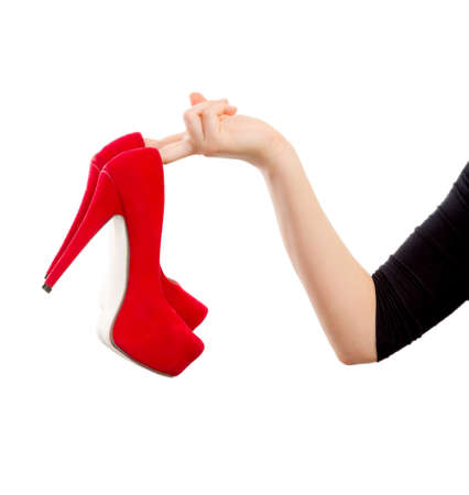 Picture of a woman hand holding red high heelsの写真素材