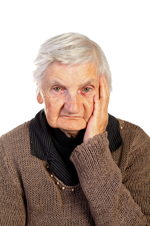 Picture of an elderly woman touching her headの写真素材