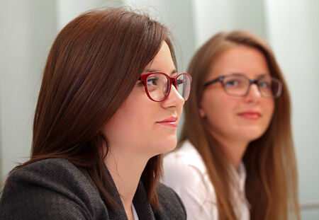 Two business women sitting at a conferenceの写真素材